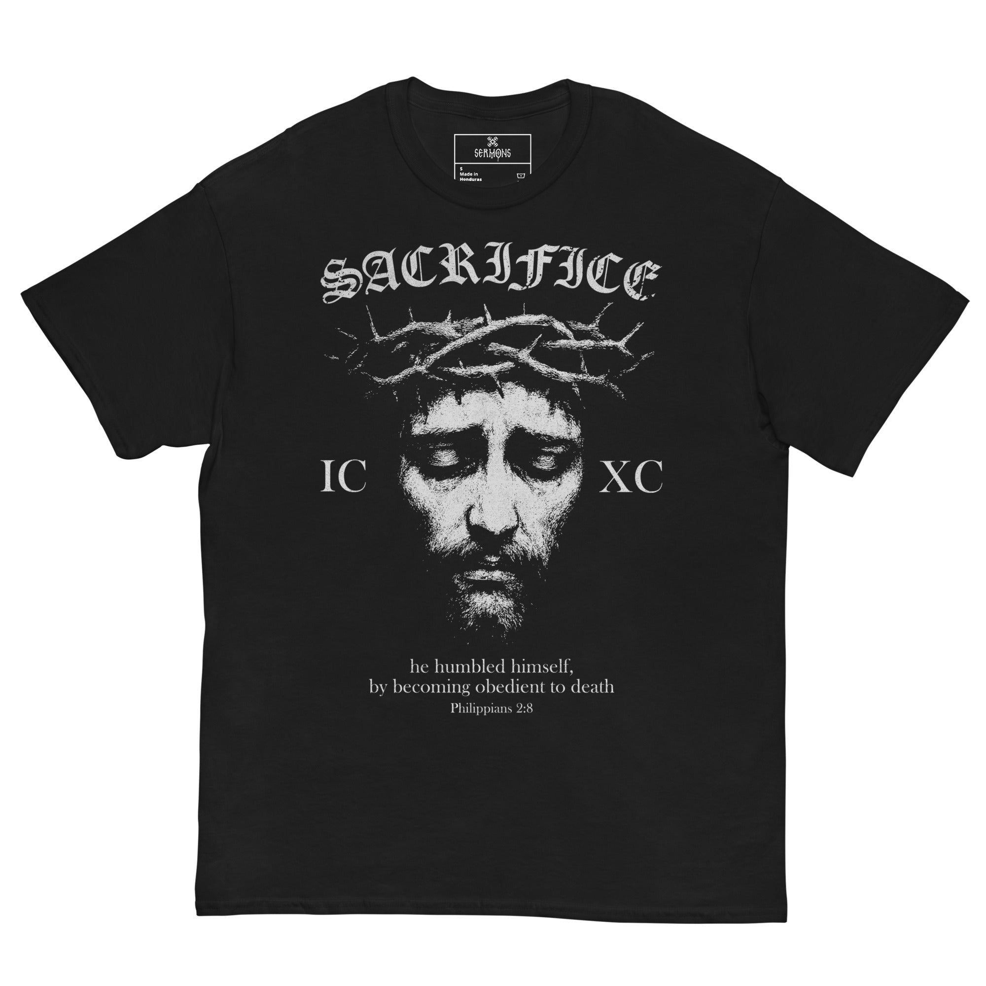 Front view of the black Sacrifice unisex T-Shirt featuring Christ crowned with thorns, the inscription SACRIFICE above, and the verse from Philippians 2:8 — 'he humbled himself, by becoming obedient to death' — Orthodox Christian clothing design